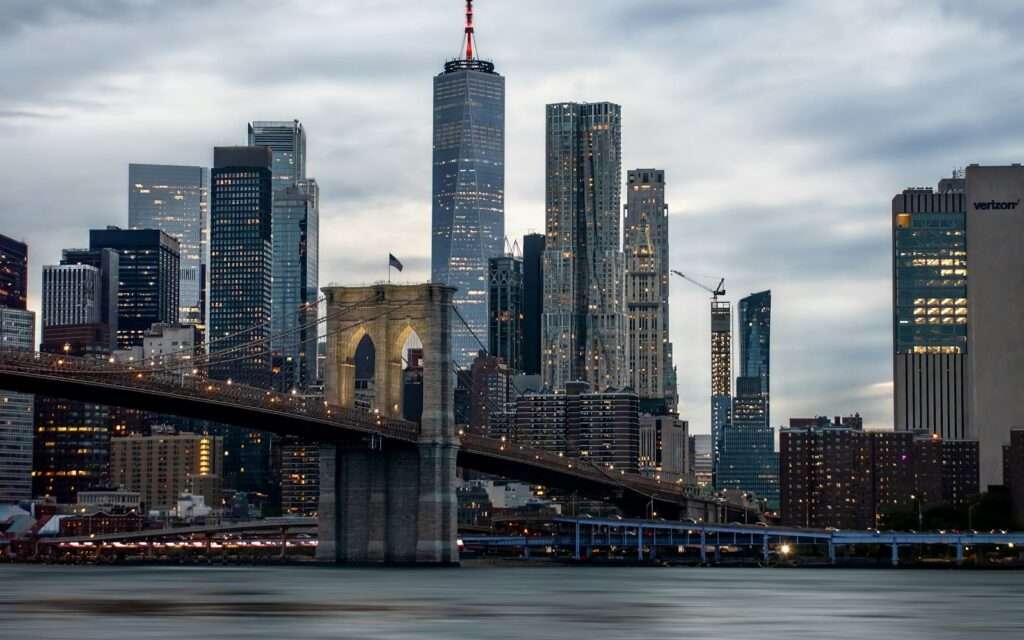The Brooklyn Bridge against the Lower Manhattan skyline at dusk